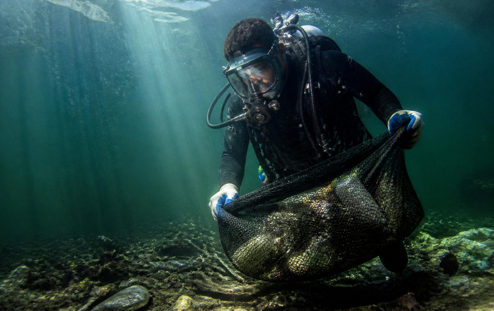 SWEEPAM dive team recovering submerged plastic waste from a Lagos lagoon